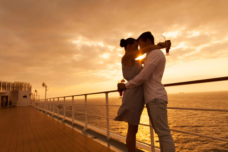 Romantic,Couple,Hugging,With,Eyes,Closed,At,Sunset,On,A